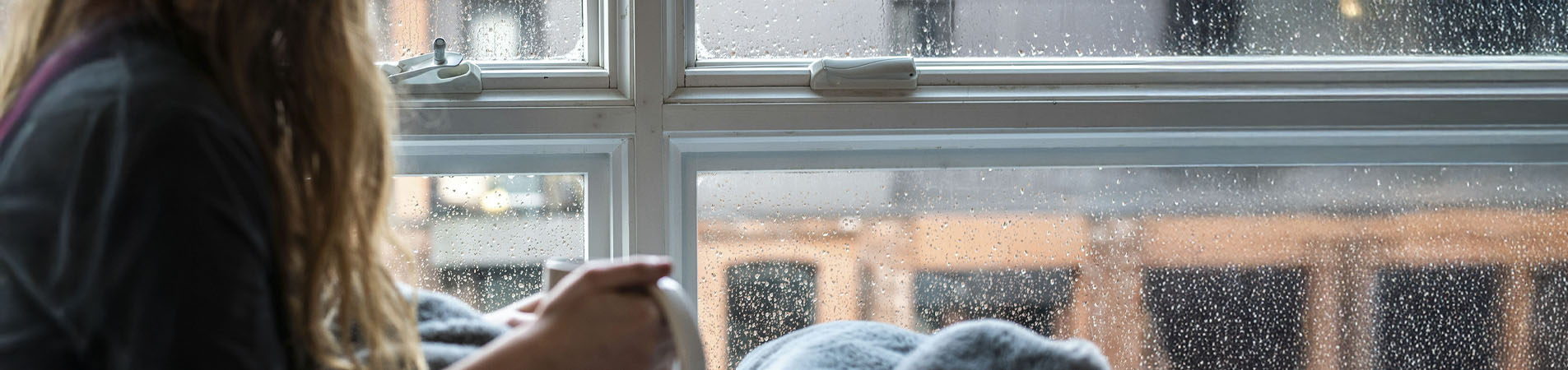 A woman thinking about which water damage home insurance she should buy.